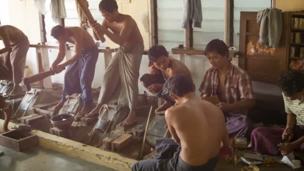 MANDALAY, MYANMAR - 13 JAN 2014: Goldbeating is the process of hammering gold into an extremely thin unbroken sheet for gilding. — Stock Video