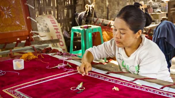 MANDALAY, MYANMAR - 13 JAN 2014: Burmese tapestry masters work with kalaga. It is a heavily embroidered applique tapestry made of silk, flannel, felt, wool and lace against cotton or velvet background — Stock Video