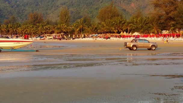 KAMALA, THAILAND - CIRCA MAR 2014: Evening, the end of the working day. Locals pull the boat out of the water — Stock Video