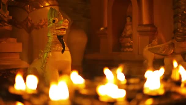 Vídeo 1080p - Estátuas de monstros míticos em um templo budista à noite. Iluminação ritual com lâmpadas de óleo. Birmânia, Rangum — Vídeo de Stock