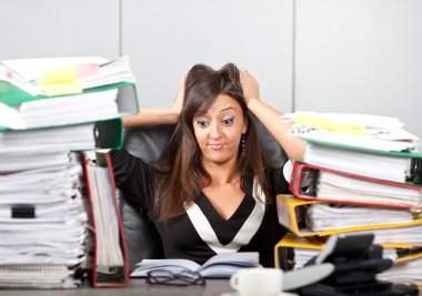 Stress on work.woman holding her head clipart