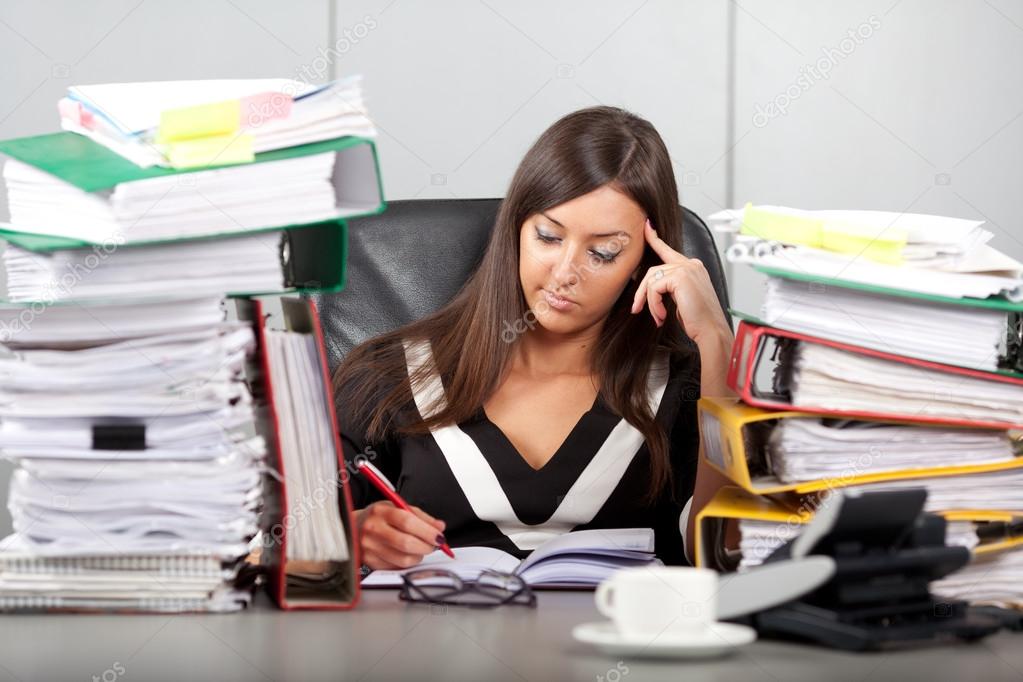 over-worked woman in office