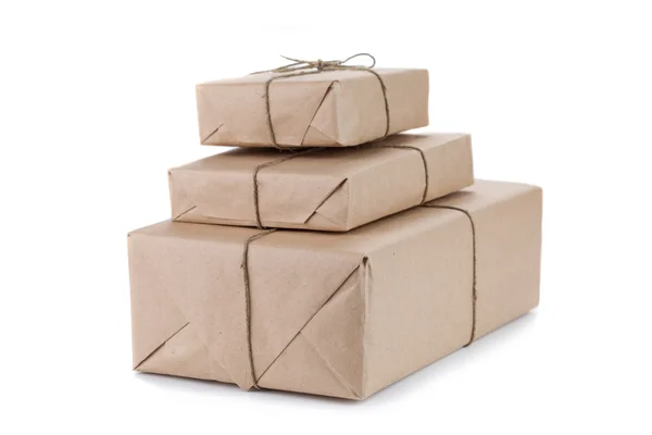 Cardboard carton wrapped with brown paper and tied with string — Stock Photo, Image