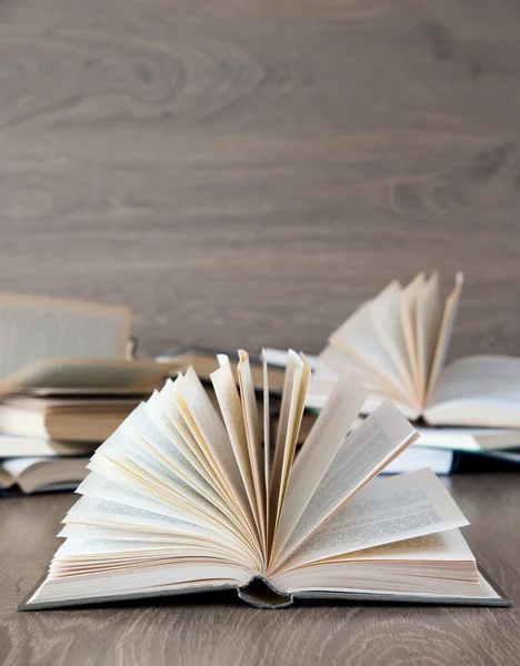 Books on wooden deck tabletop — Stock Photo, Image