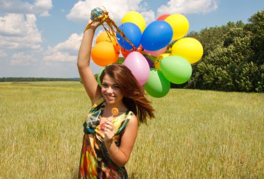 mutlu genç kadın ve renkli balonlar