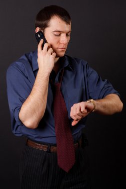 siyah arka plan üzerinde duran yakışıklı genç iş adamı