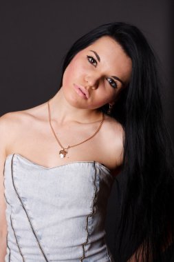 Sexy brunette in a dress on a black background