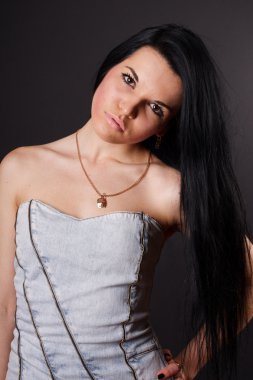 Sexy brunette in a dress on a black background