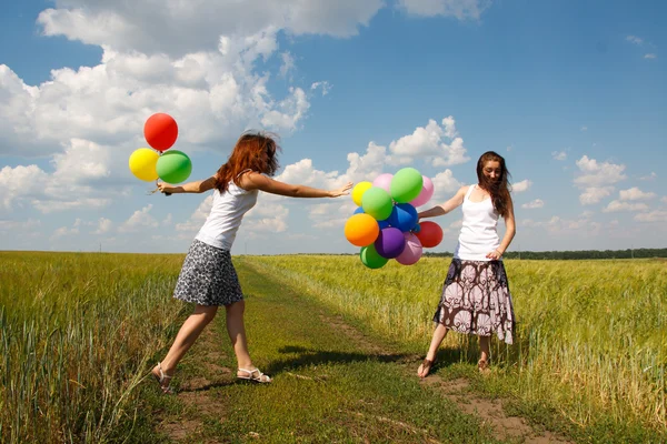 Happy young woman and colorful balloons — Stock Photo, Image