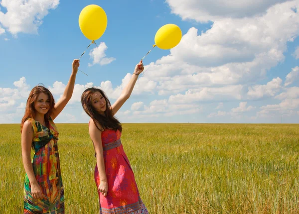Счастливые молодые женщины и красочные воздушные шары — стоковое фото