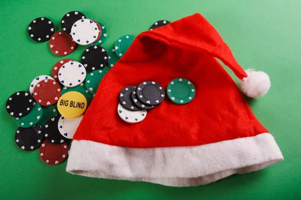 Casino gambling chips and a cap of Santa Claus — Stock Photo, Image