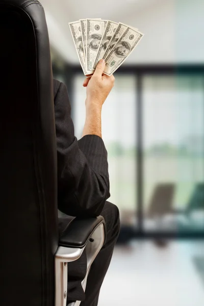 Businessman holds money in hands — Stock Photo, Image