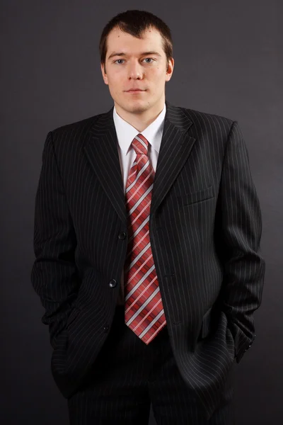 Handsome young business man on black background — Stock Photo, Image