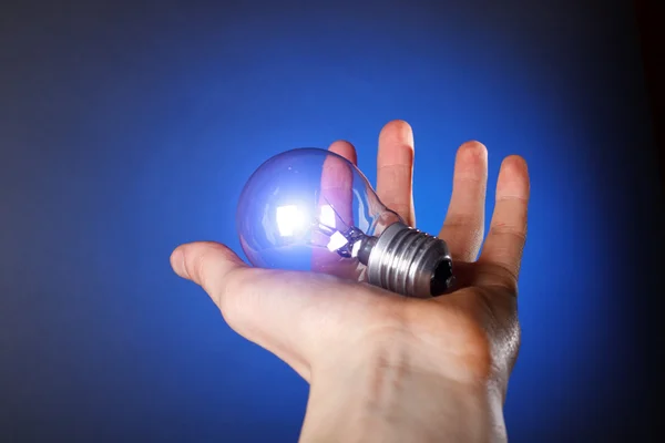 Light bulb in his hand — Stock Photo, Image