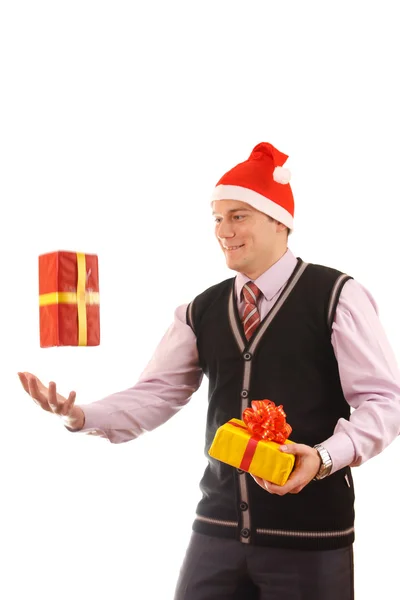 Young businessman in santa hat offering a gift to you — Stock Photo, Image