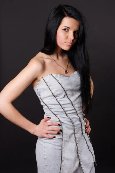 Sexy brunette in a dress on a black background — Stockfoto