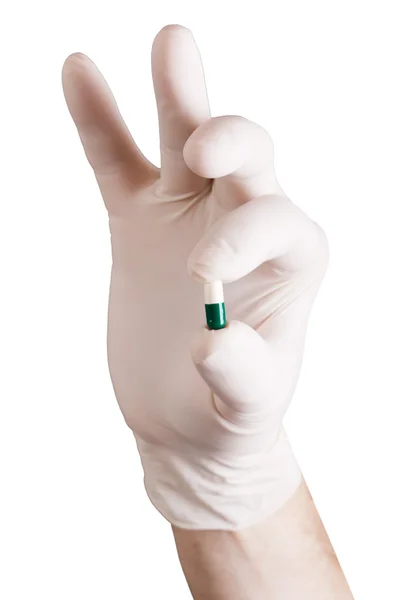 Таблетки в руці на білому тлі — стокове фото
