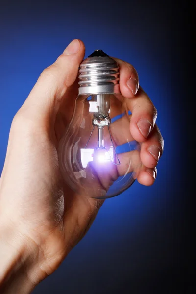 Light bulb in his hand — Stock Photo, Image