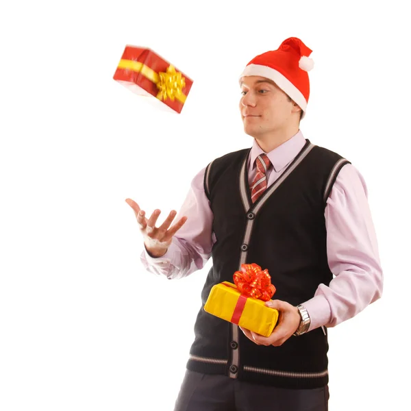 Young businessman in santa hat offering a gift to you — Stock Photo, Image