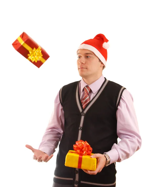 Young businessman in santa hat offering a gift to you — Stock Photo, Image