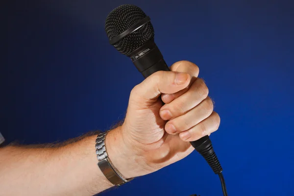 Microphone in hand — Stock Photo, Image