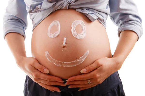 Abdomen une jeune femme enceinte avec un visage souriant — Photo