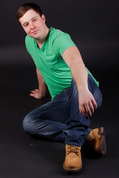 A young man sitting on the floor Stock Image