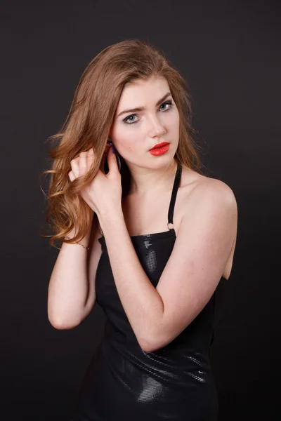 Pretty young woman in a black dress. Stock Image