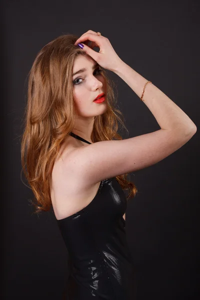 Pretty young woman in a black dress. Royalty Free Stock Images