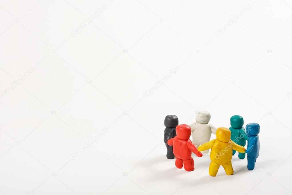 Human figures from clay stand in a circle