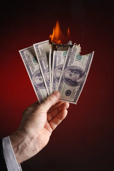 Burning dollar i hand — Stockfoto