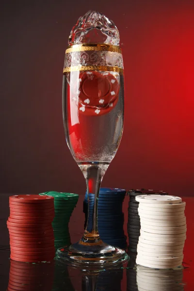 Poker chips in the glass of water. — Stock Photo, Image