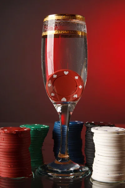 Poker chips in the glass of water. — Stock Photo, Image