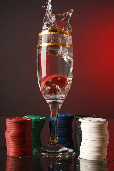 Poker chips in the glass of water. — Stock Photo, Image