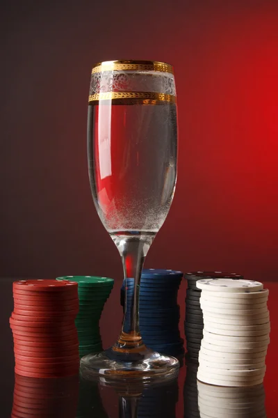 Poker chips in the glass of water. — Stock Photo, Image