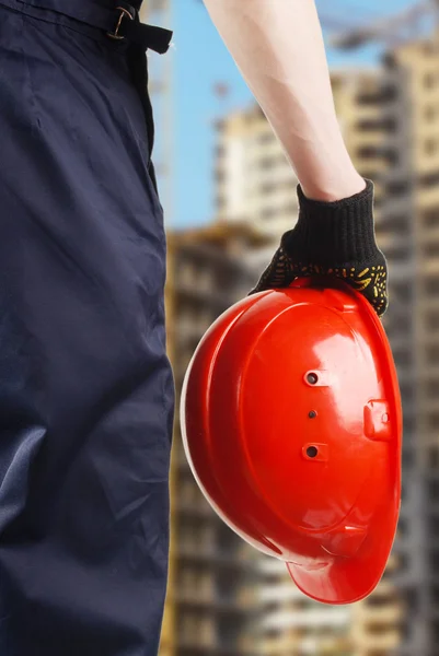 Construction hard hat in hand — Stock Photo, Image