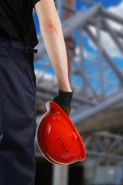 Construction hard hat in hand — Stock Photo, Image