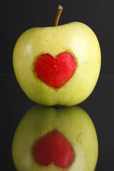 Green apple with red heart sign — Stock Photo, Image