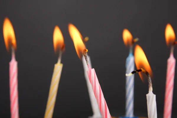 Algumas velas de aniversário acesas fecham — Fotografia de Stock