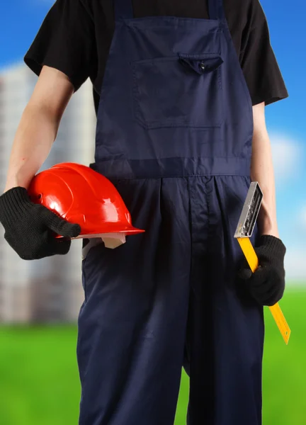 Construction hard hat in hand — Stock Photo, Image