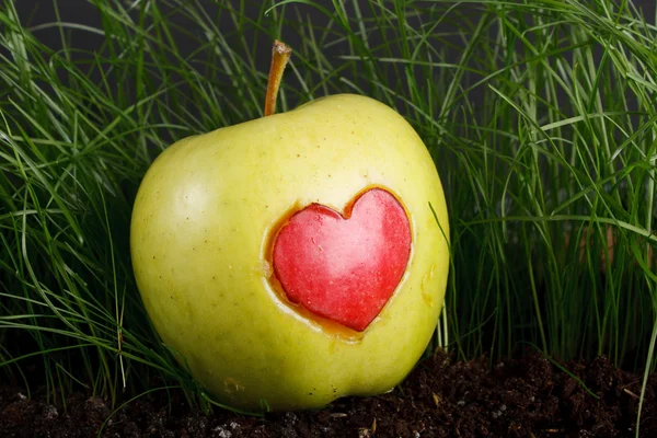 Green apple with red heart sign — Stock Photo, Image