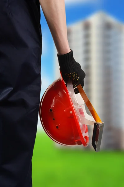 Construction hard hat in hand — Stock Photo, Image