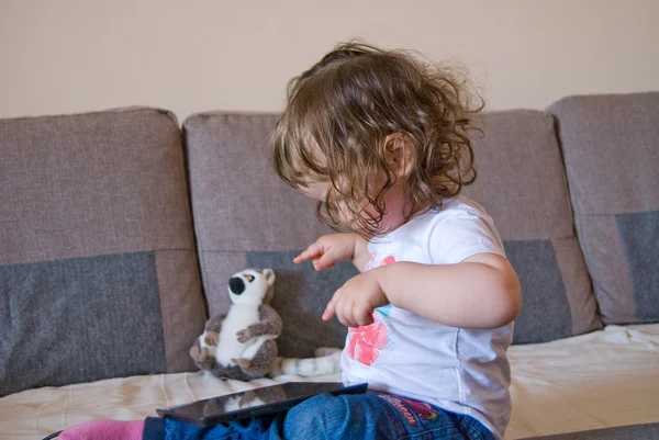 The baby girl is playing on laptop — Stock Photo, Image