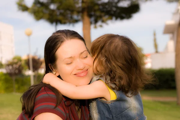 The little girl is kissing her mother — Stock Photo, Image