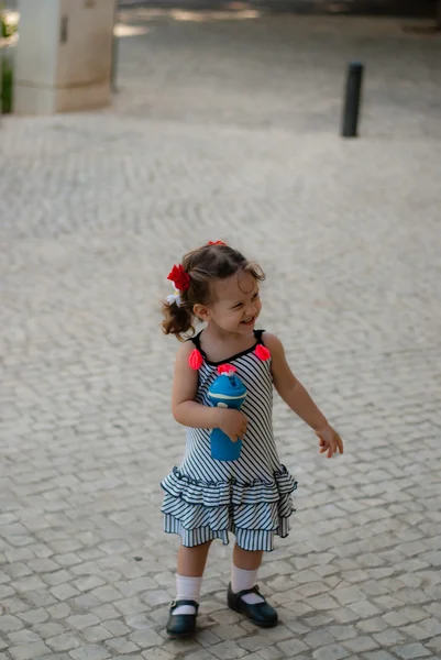 The baby girl walking alone in street — Stock Photo, Image