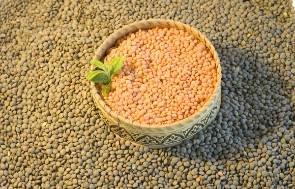 Orange lentils on green lentils backgrond — Stock Photo, Image