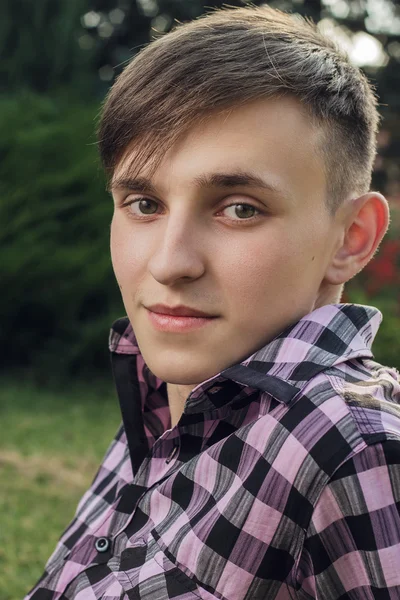 Portrait of young handsome man in park — Stock Photo, Image