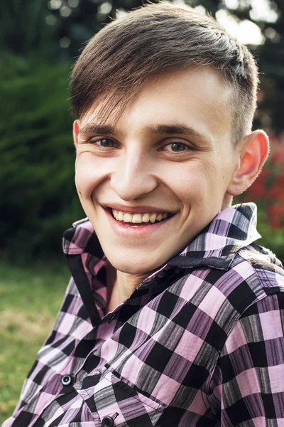 Portrait of happy young man in park — Stock Photo, Image