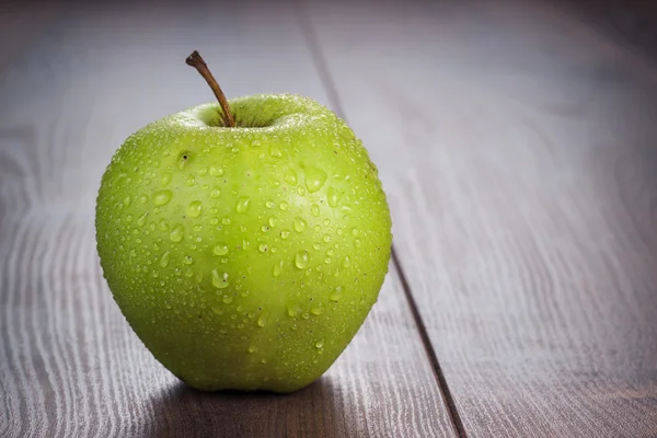 Färskt grönt äpple på bordet — Stockfoto