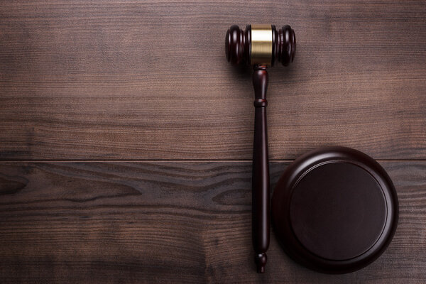 Judge gavel on brown wooden background